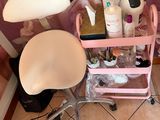 a pink cart with a lot of beauty products on it