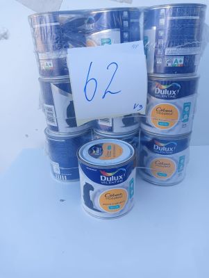 several cans of blue paint are stacked on top of each other