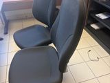 a black office chair sitting in front of a computer desk