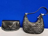 two purses are sitting next to each other on a table