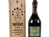 a bottle of wine sitting next to a wooden box