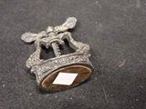 a small metal object with a tag on top of it