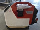 an image of a red and white lawn mower in a garage