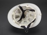 a white hard hat with a black strap on it