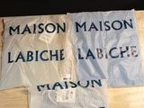 three shirts that are on a table with a name on them