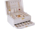 an image of a white jewelry box with many compartments
