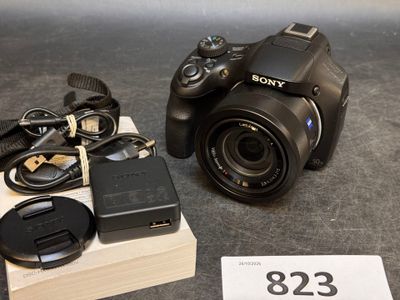 a sony camera and a charger sitting on a table