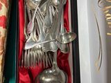 a box with silver spoons and spoons inside of it