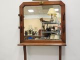 a mirror on a table with a lamp on it
