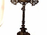 a cross that is on a stand with a white background