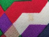 close up of a multicolored blanket with a pattern on it