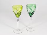 pair of green and yellow glass goblets on a white background