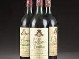 three bottles of wine sit on a table in front of a black background