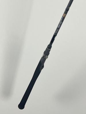 a close up of a fishing rod on a white surface