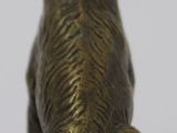 bronze figurine of a dog sitting on its hind legs