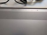 a laptop computer with a charger on top of it
