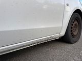 a white car that is parked on the side of the road