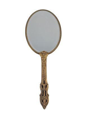 an antique brass mirror with a white glass in the middle