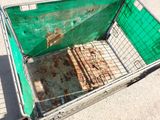 a green shopping cart sitting on the ground outside