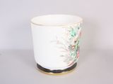 a white cup with a floral design on it