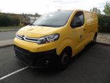 yellow van parked in a parking lot next to a curb