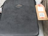 two bags sitting on a table with a price tag