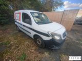 a small white van parked in a yard
