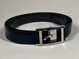 a black belt with a silver buckle on a white surface