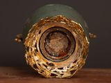a close up of a vase on a wooden table