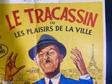 a poster of a man in a suit and hat on a wall