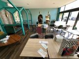 a room with a lot of tables and chairs in it