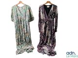 two dresses hanging on a clothes rack on a white background