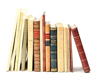 a lot of books that are stacked on top of each other