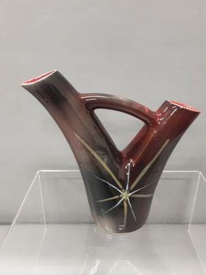 a vase that is sitting on a clear shelf