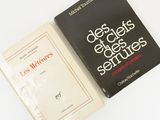 two books sitting next to each other on a white surface