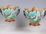 pair of vases with birds and flowers painted on them on pedestals