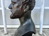 bronze bust of a man with a beard on a black base