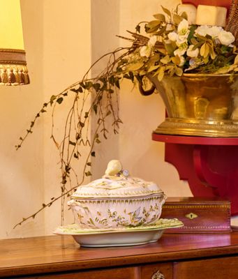 une table sur laquelle sont posés un vase de fleurs et une lampe