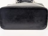 a black suitcase sitting on a white surface