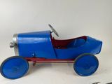 a small blue toy car sitting on a white surface