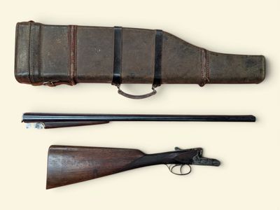 an old gun with a leather case and a wooden handle