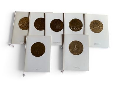 six books with gold coins on them sitting next to each other