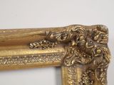 a gold frame with a picture of a woman on it