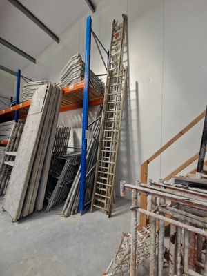 a large room with a lot of shelves and ladders in it