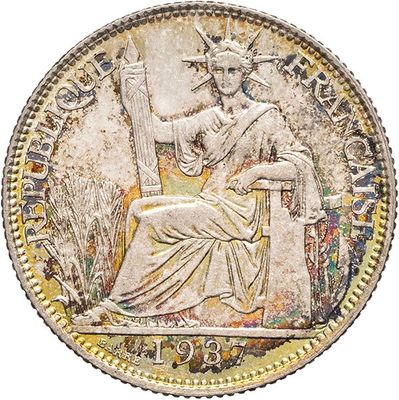 a silver coin with a statue of a woman sitting on a chair