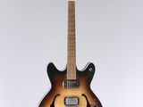 an electric guitar hanging from the ceiling