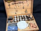 a wooden box with a variety of items inside of it