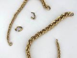 a close up of a gold chain on a white surface