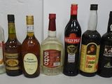 many different types of alcohol bottles lined up on a table