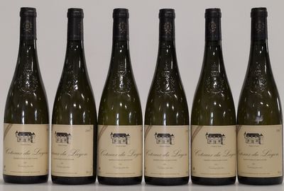six bottles of wine are lined up on a table